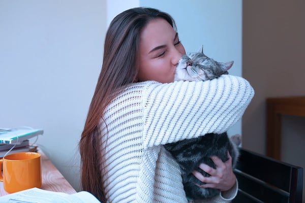 female-student-hugging-her-pet-cat